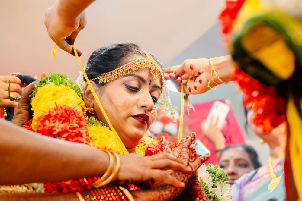 Traditional Indian haldi ceremony with turmeric paste being applied during pre-wedding rituals.