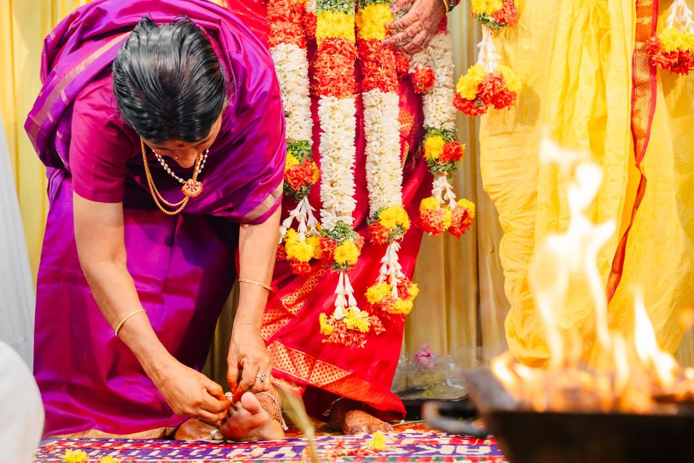 Sacred fire ritual during traditional Hindu wedding ceremony with decorative floral arrangements.