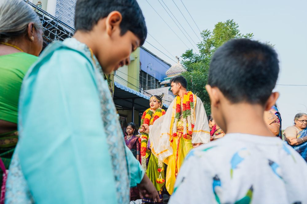 Outdoor gathering during an Indian wedding ceremony with guests in traditional attire.