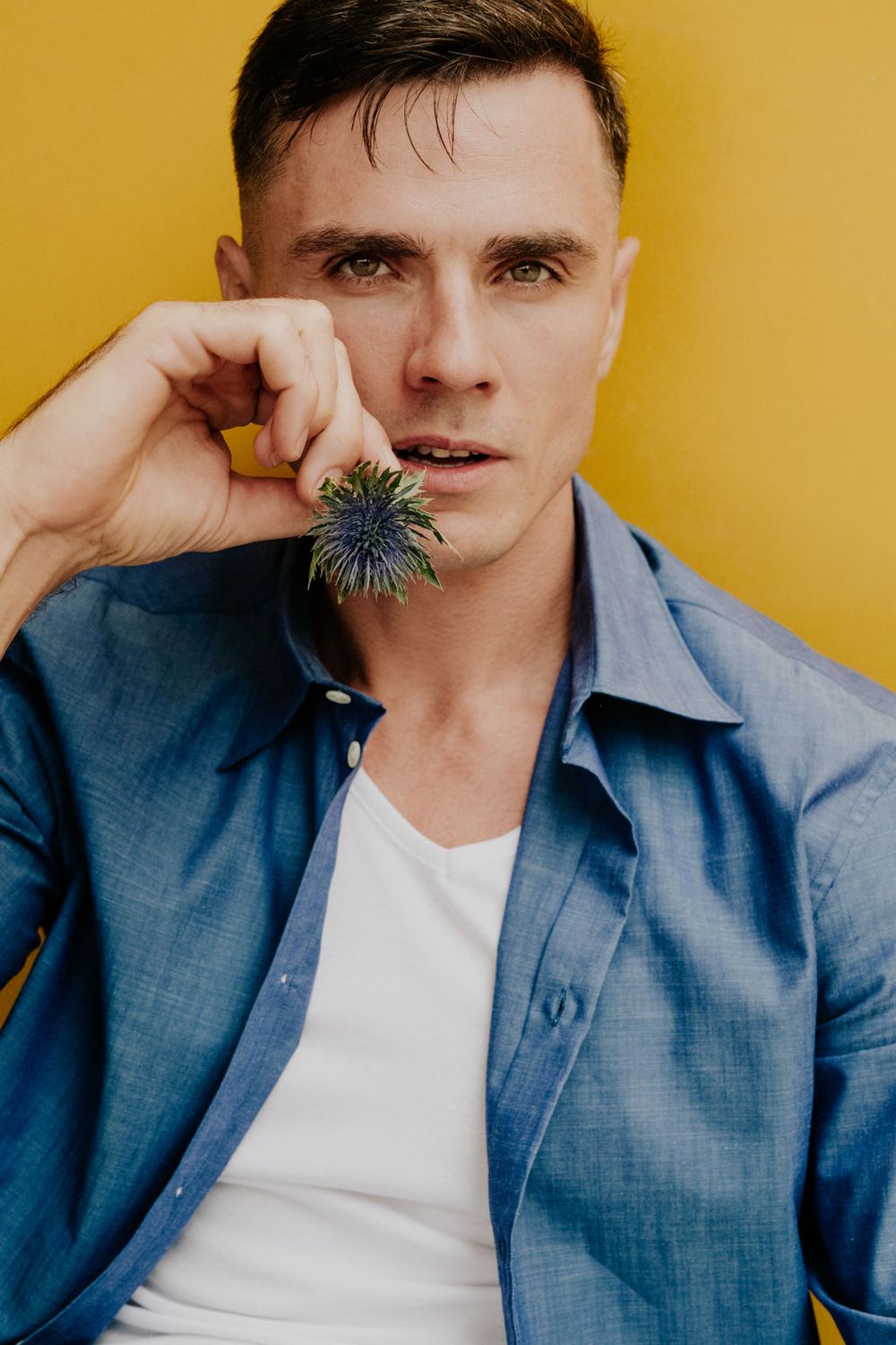Series of expressive portraits with person in blue shirt against yellow background.