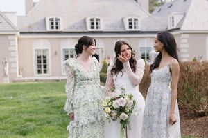 Candid moment of a bride chatting with her two bridesmaids.