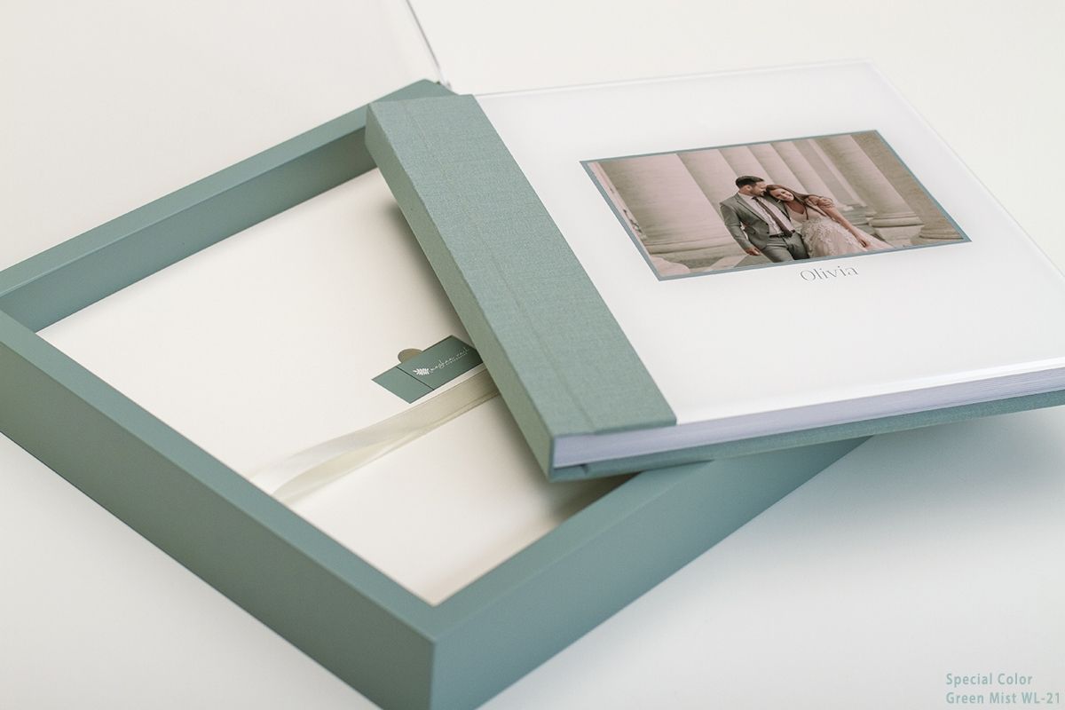 Elegant sage green photo album frame and matting shown disassembled against white background.