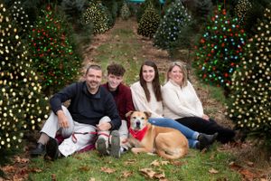 Holiday photo with family and pet dog at Deerfield Tree Farm in Millis Massachusetts