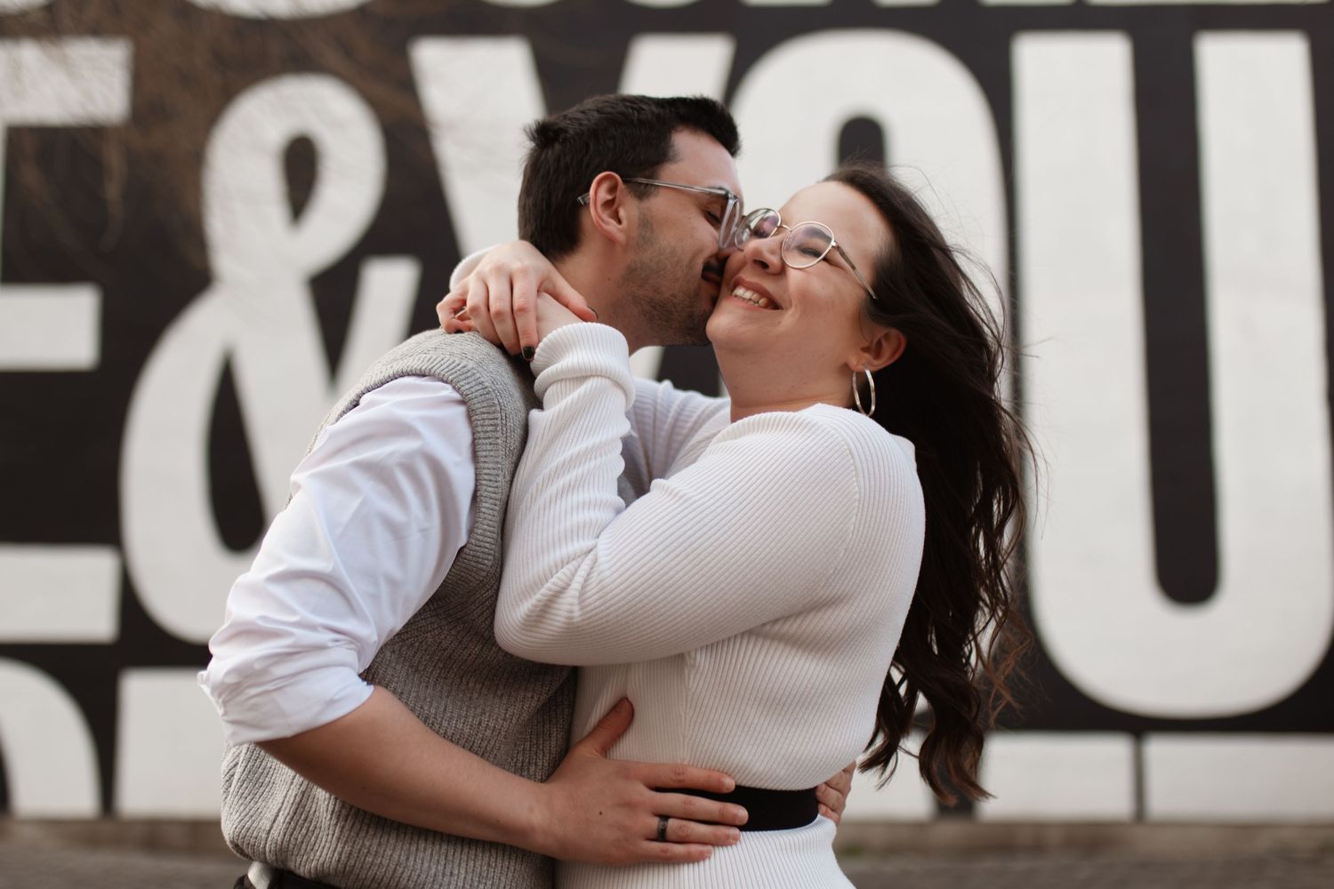 Close-up of two hands touching with an engagement ring prominently displayed. Pre wedding photoshoot. Leeds City Centre Pre Wedding Photos.