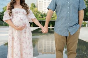 maternity photo of mother and father to be holding hands in myriad gardens in okc, ok for Oklahoma City maternity photographer