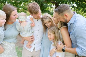 family embraces in will rogers gardens for an extended family session with OKC family photographer Lindsey K Brown photography