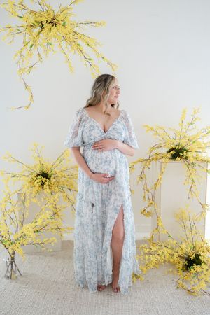 Pregnant mother poses among flowers for maternity photography at Ren Space Studio in Edmond, OK