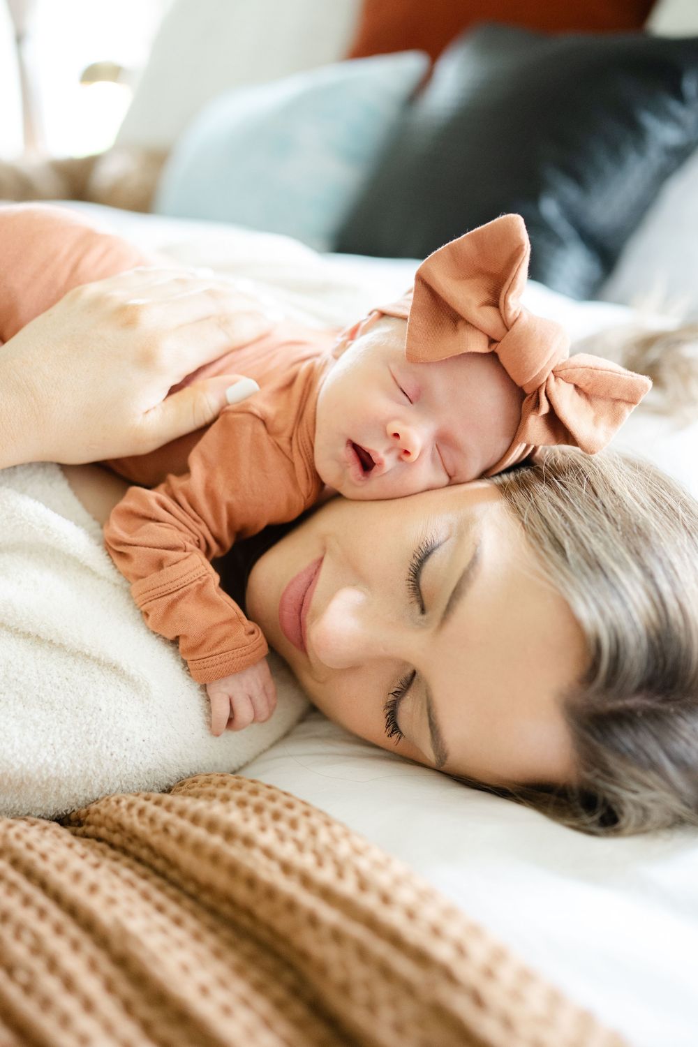 A tender moment of rest as a mother and newborn baby lie together for newborn photographer in Oklahoma City, ok