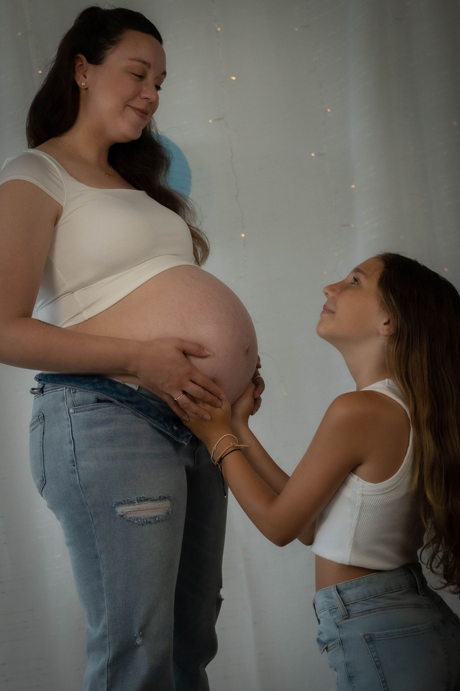 Intimate maternity photography with dramatic lighting and tender moments.