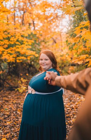 A sequence of autumn photos showing a person in a dark teal dress against vibrant orange fall foliage.