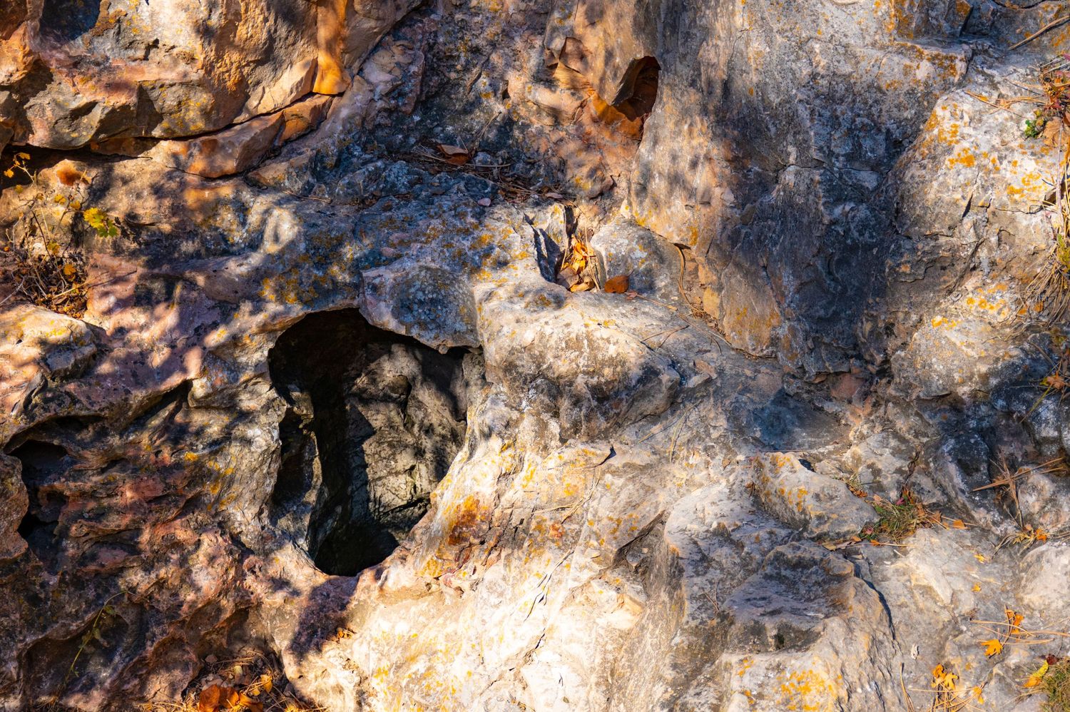 Close-up view of weathered cave walls showing natural textures and mineral patterns in the rock formation.