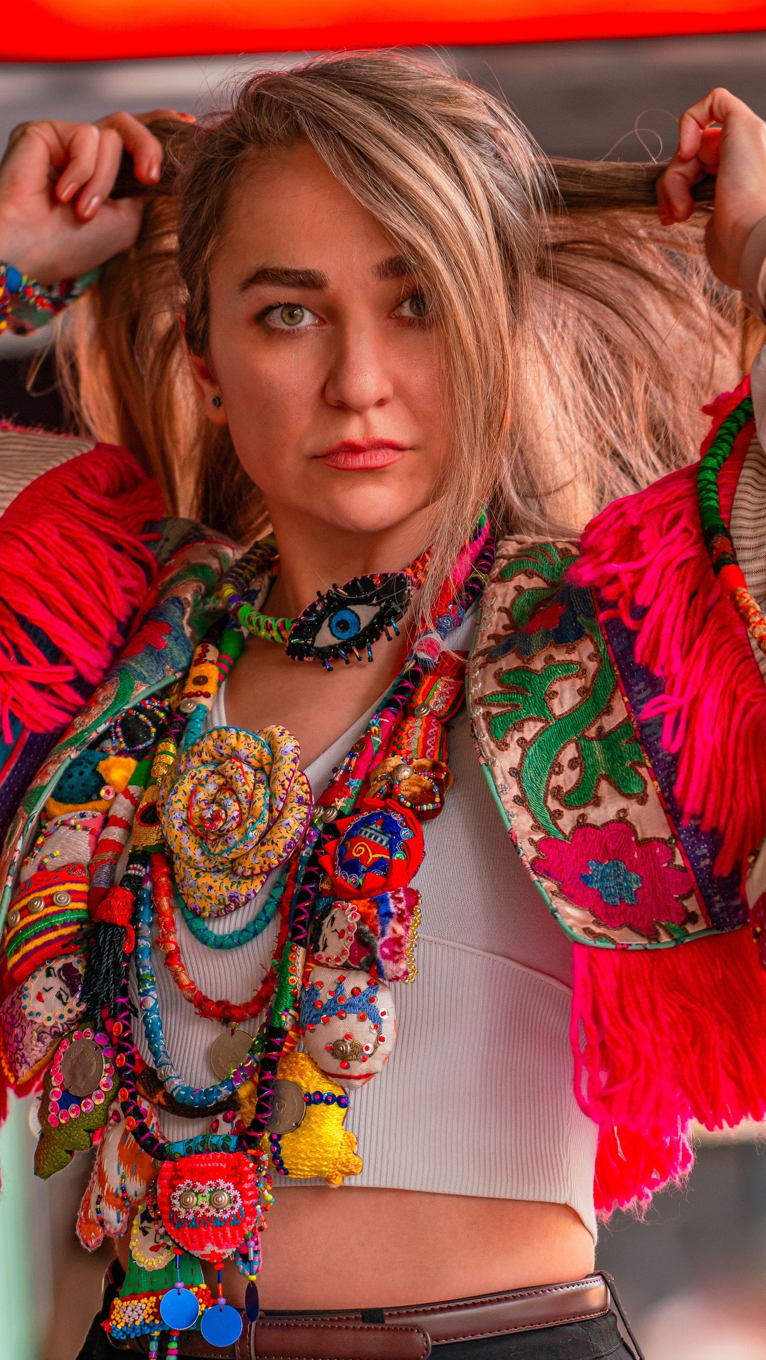 Fashion portrait with purple dress and statement jewellery outdoors