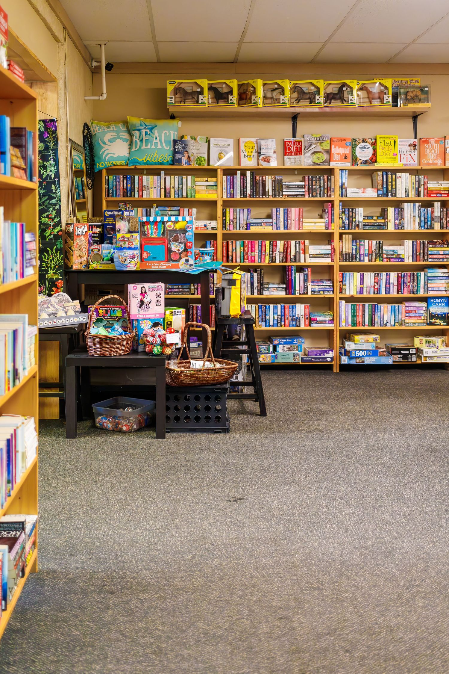 Cozy bookstore interior with wooden shelves filled with children's books and colorful displays.