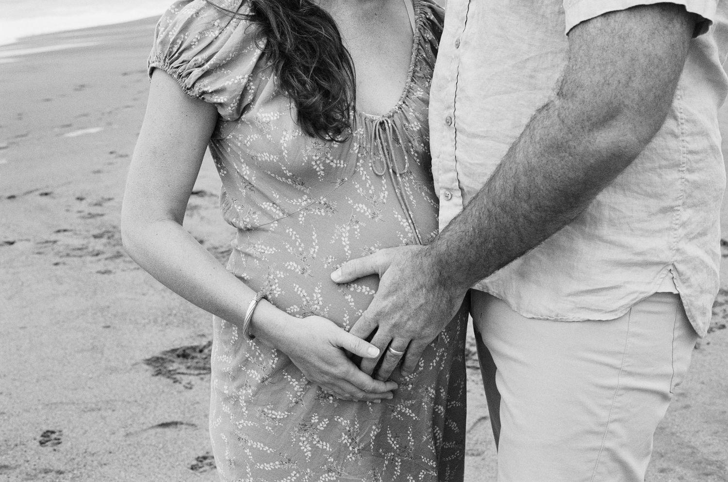 film maternity portrait with a minimalist, artistic, and emotionally driven approach beach maternity session on film with flowing dress and