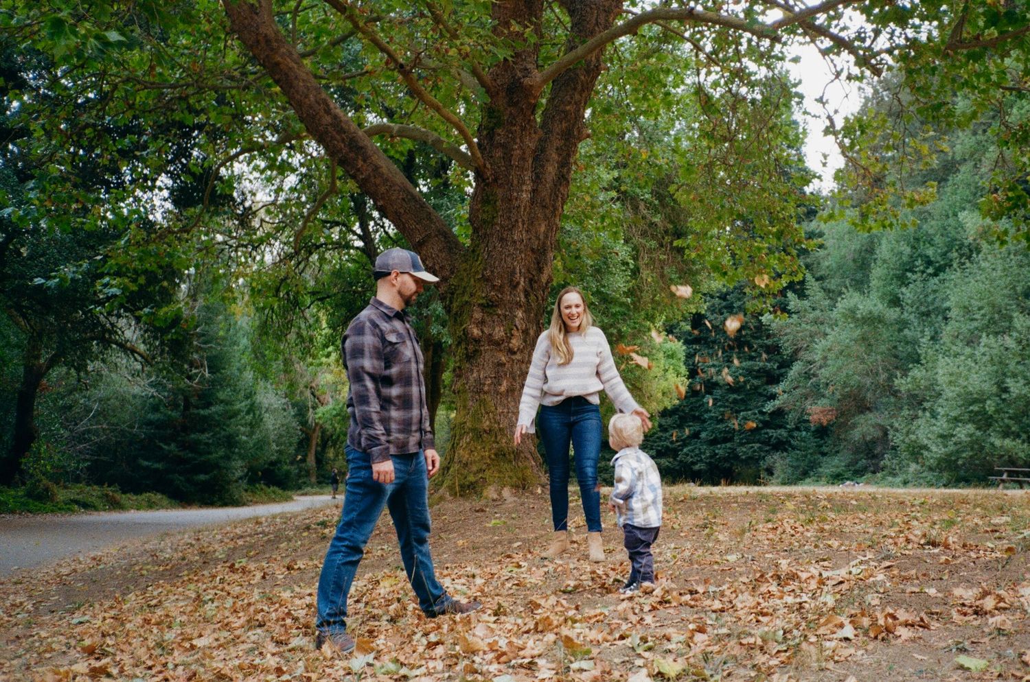 outdoor family photoshoot at golden hour with soft film tones and relaxed, joyful atmosphere