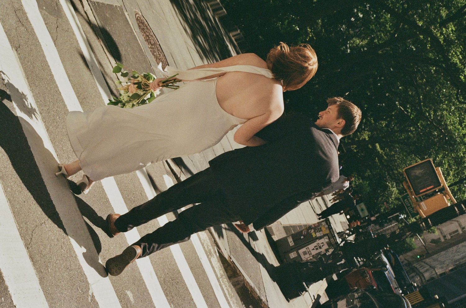 Newlywed couple walking through Manhattan after their courthouse elopement captured on 35mm film