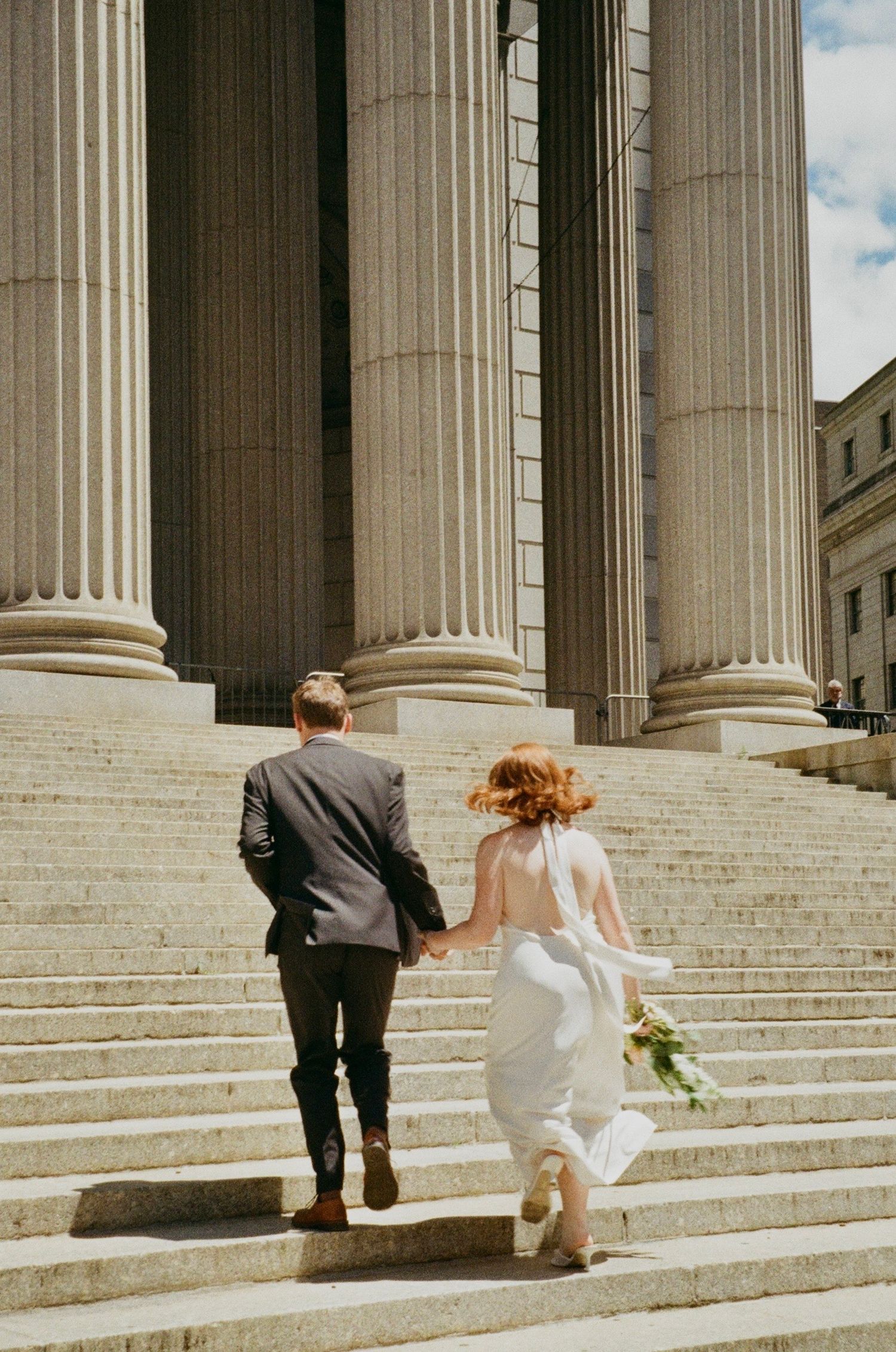 Just married couple exploring New York City streets during a cinematic elopement photography session