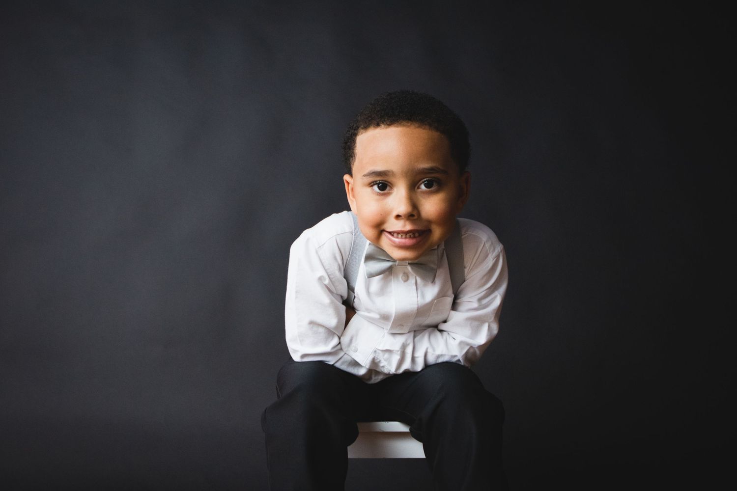 Portraits showing joyful expressions against dark backgrounds.