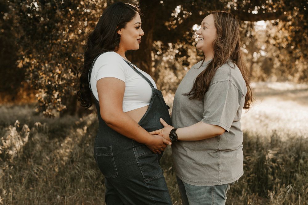 Genuine interactions photographed during an outdoor maternity portrait session at sunset.