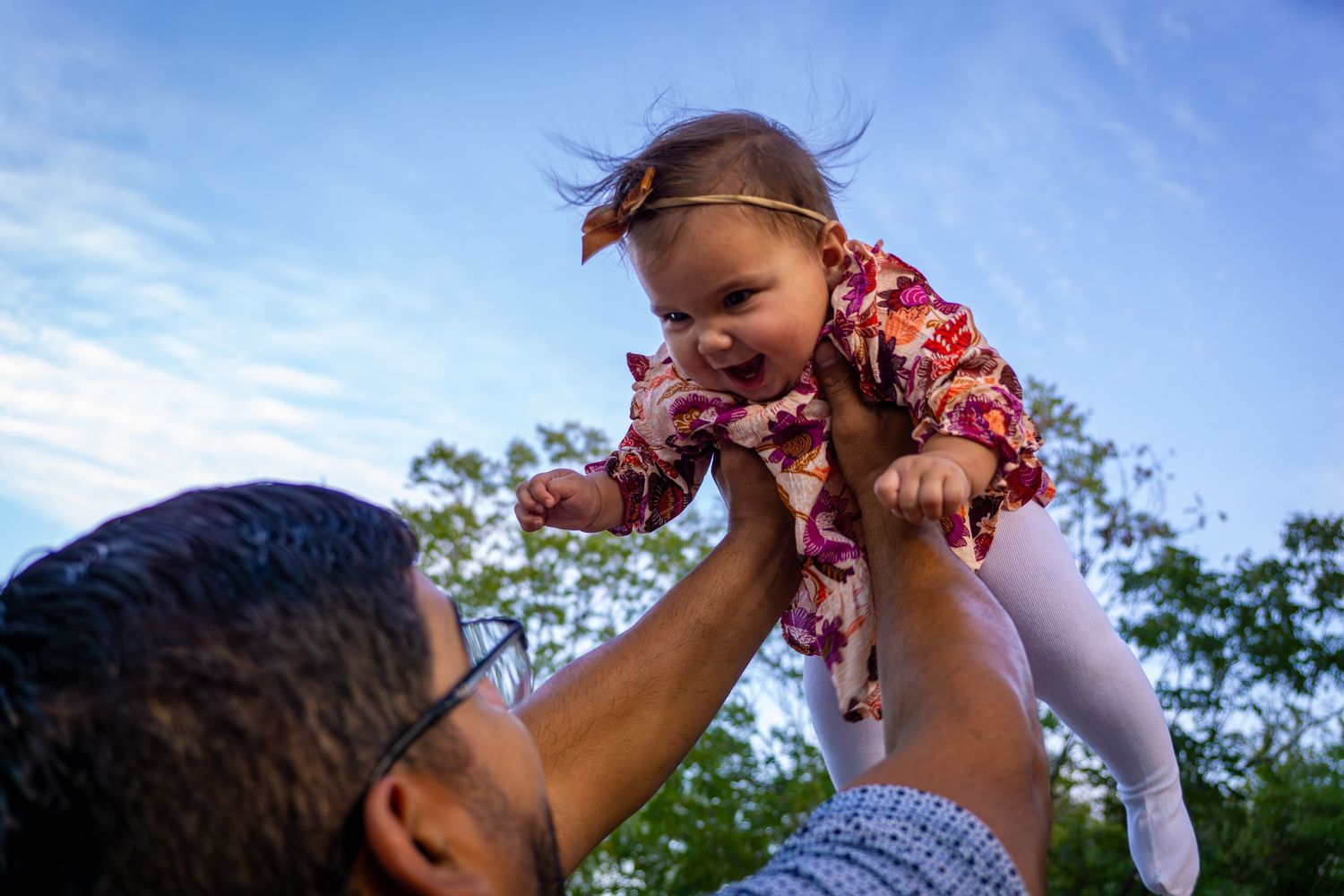 dad daughter holding her in the air love baby girl best dad ever father's day mini session family photos candid photo