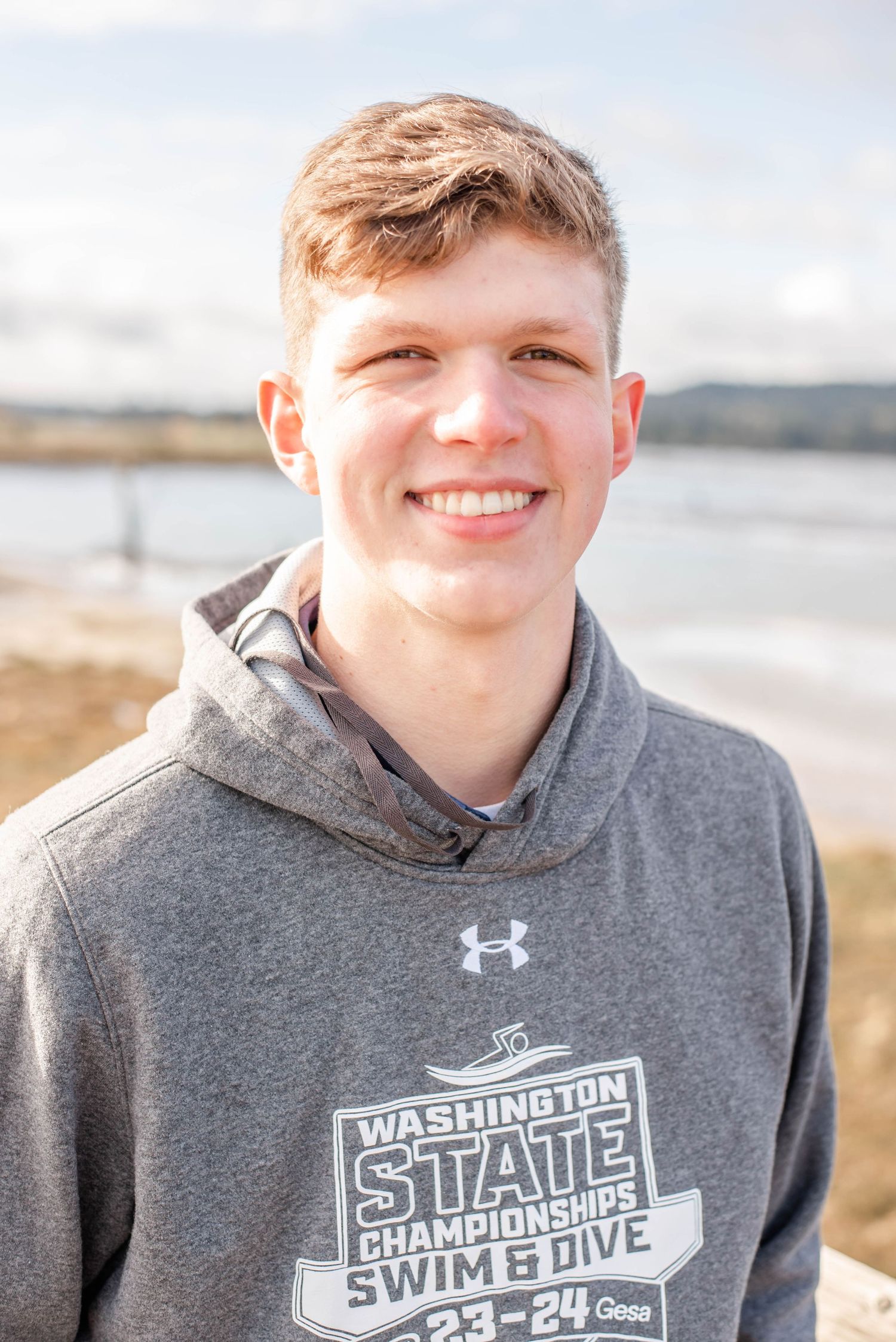 Athletic casual portrait session by the water featuring Under Armour apparel.