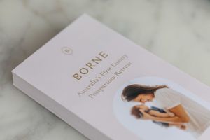 Soft focus image of a 'BORNE' branded flyer on marble surface.