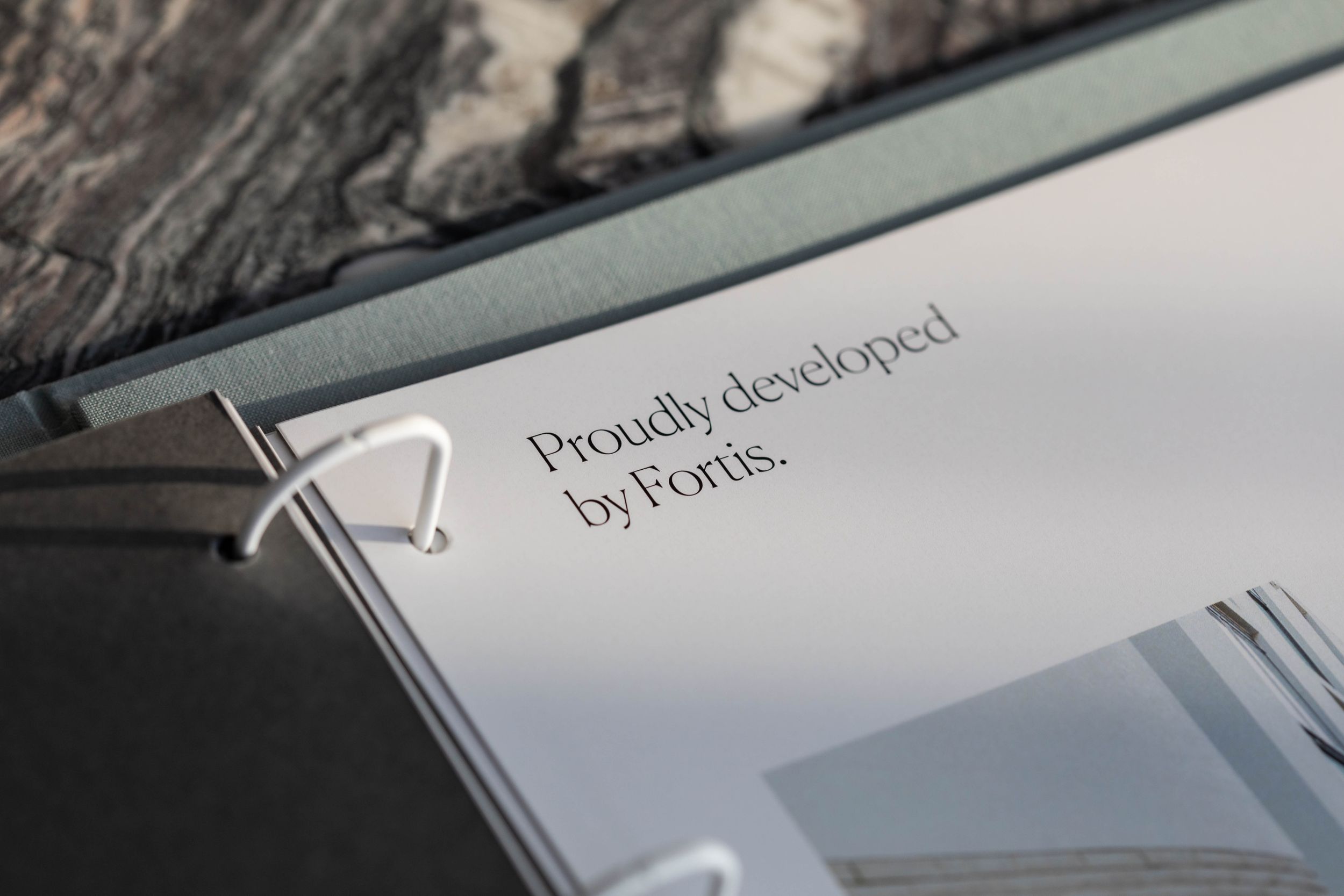 Close-up view of text reading 'Proudly developed by Ponic' engraved on metallic surface.