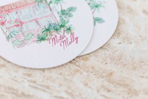 Delicate handwritten text and green floral illustrations on a round white coaster.