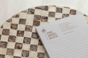 A checkered recipe book or journal page with vintage brown and white pattern lies open on a surface.