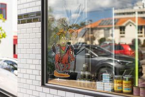 White brick wall decorated with a colorful painted mural depicting crowned figures and cartoon-style characters.