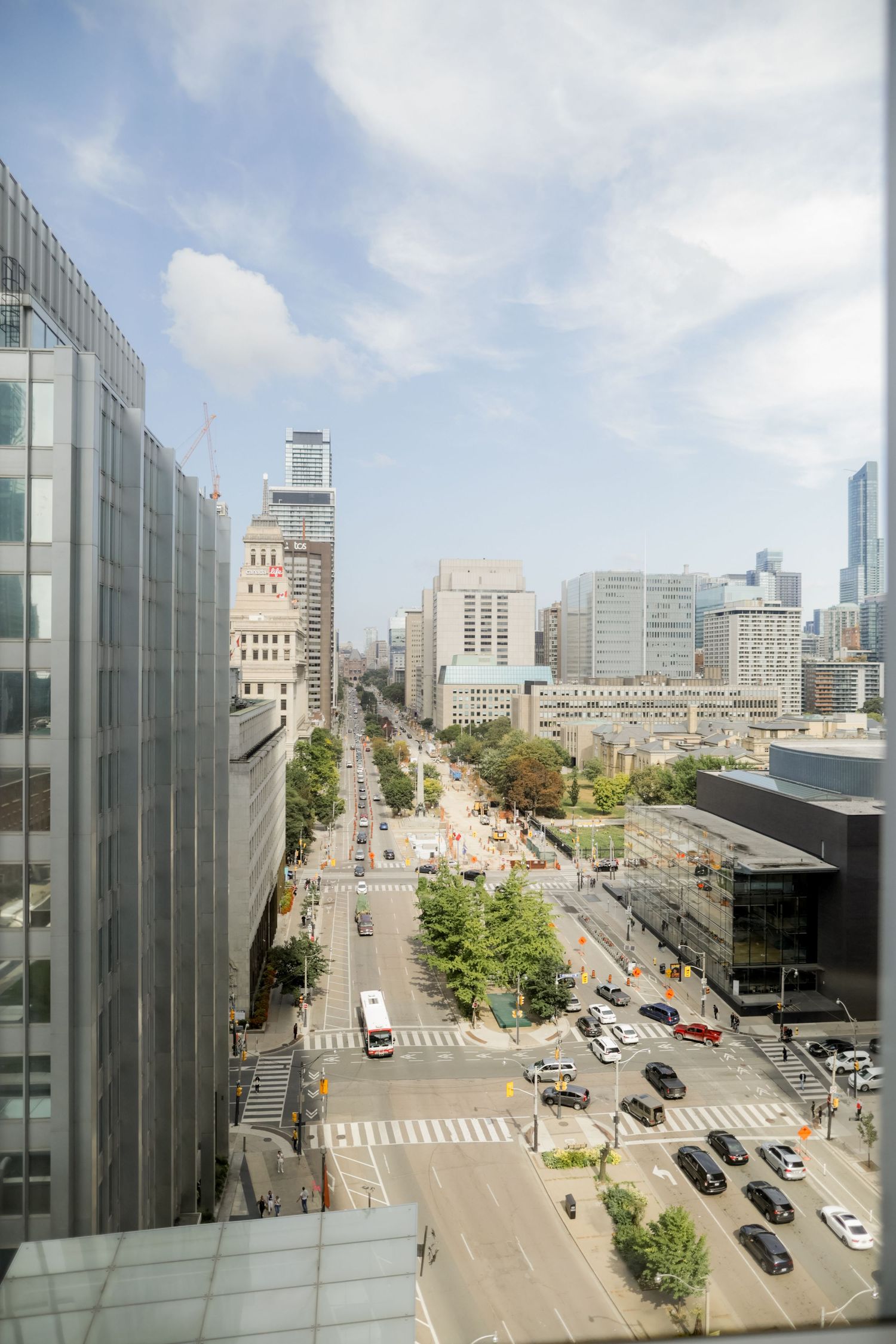 High angle view of an urban intersection with traffic and buildings in a downtown setting.