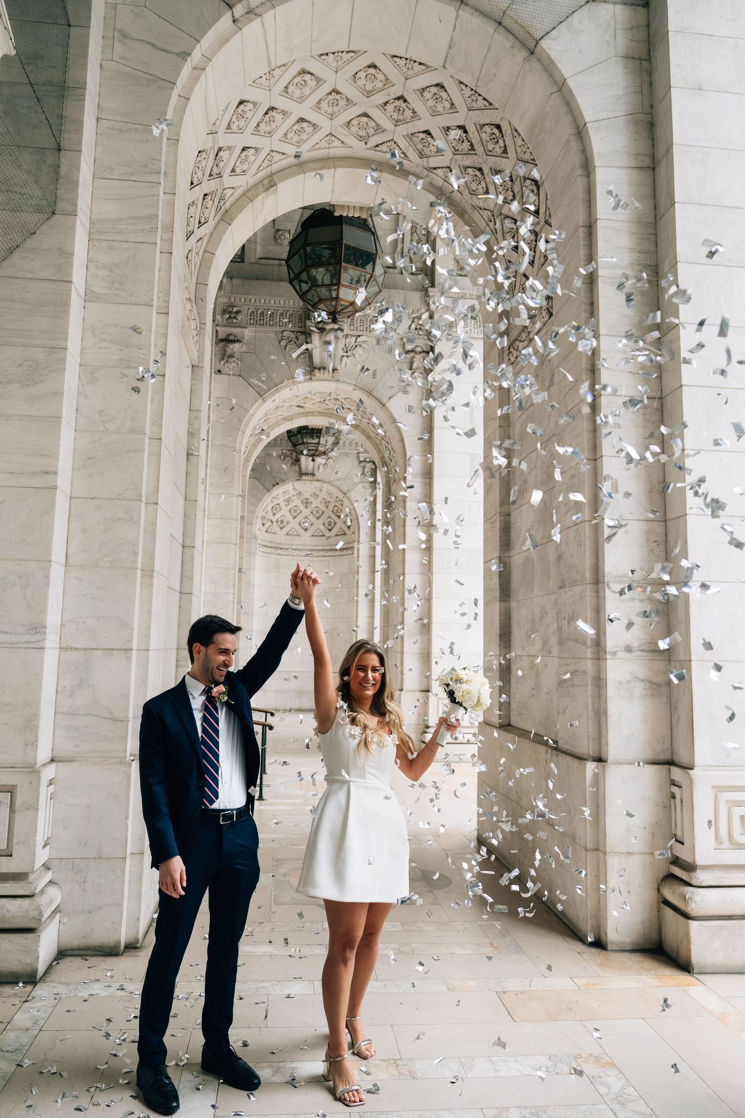 A couple celebrates under ornate stone arches while confetti petals fall around them in a romantic photo sequence.