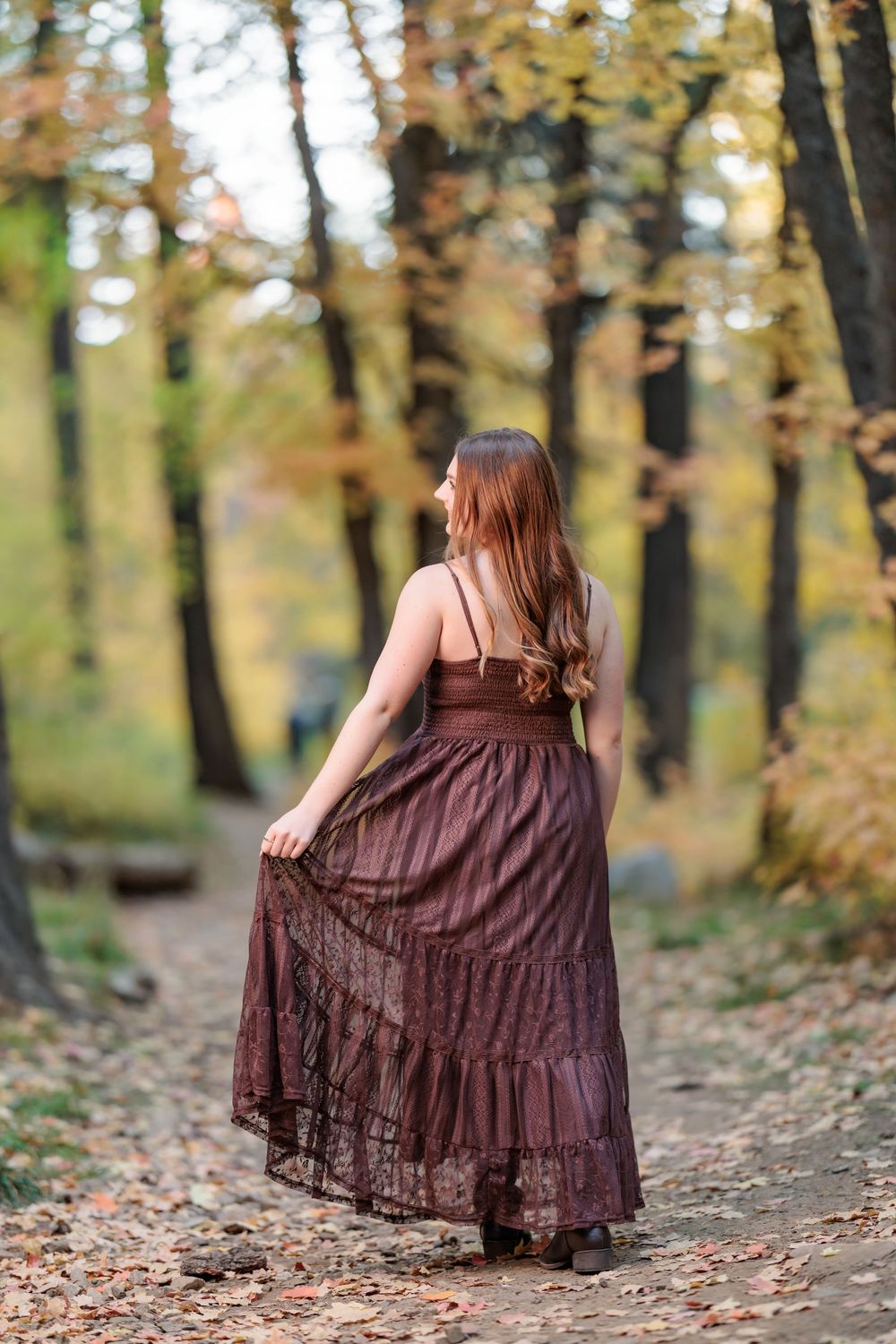 Fall leaves senior girl in flowing dress