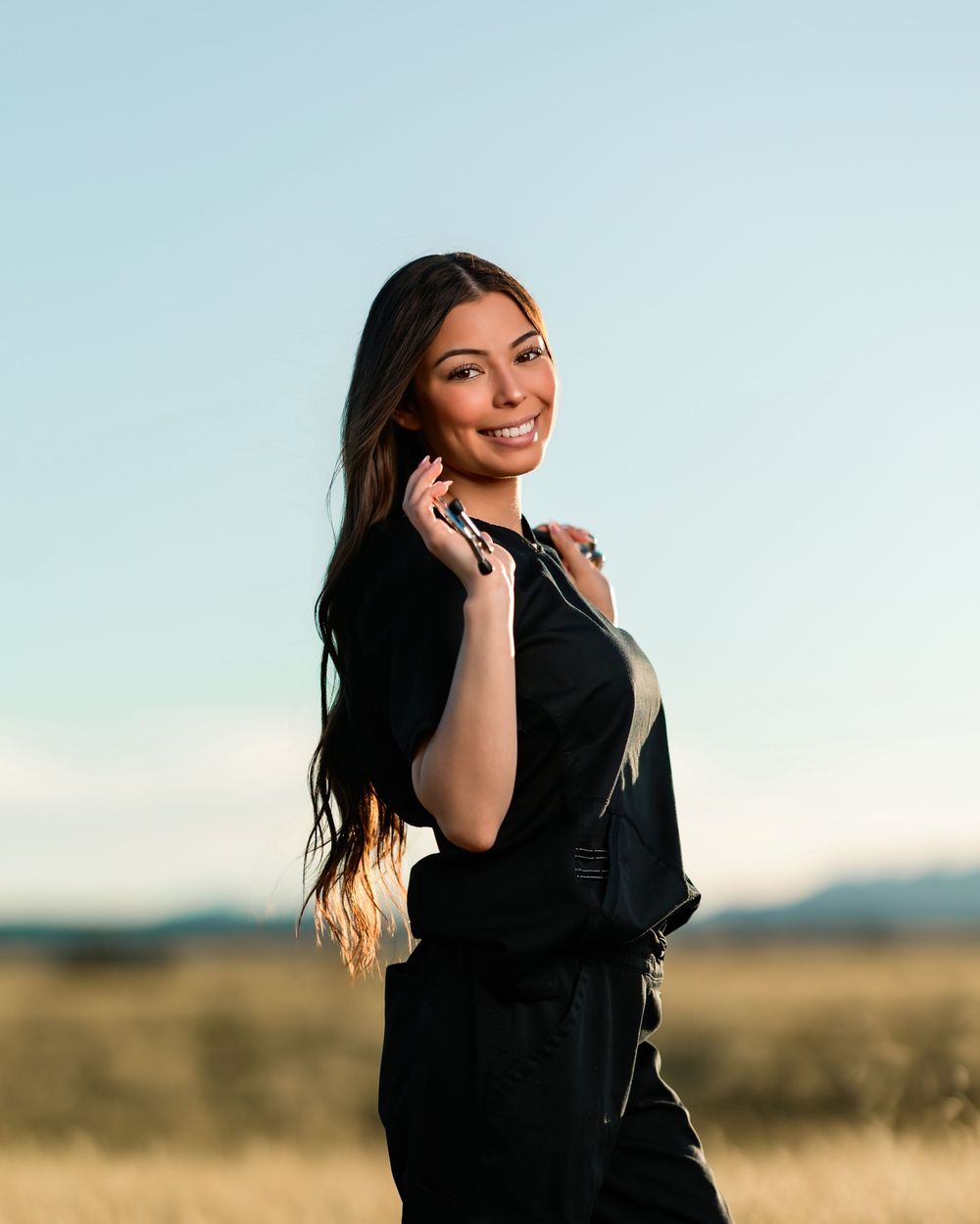senior girl picture with stethoscope in scrubs Tuscon, AZ field with mountain views
