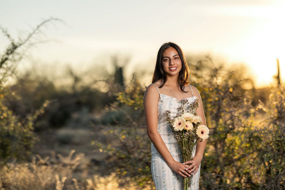 Tucson, AZ senior girl in the desert at golden hour holding a bouquet of flowers