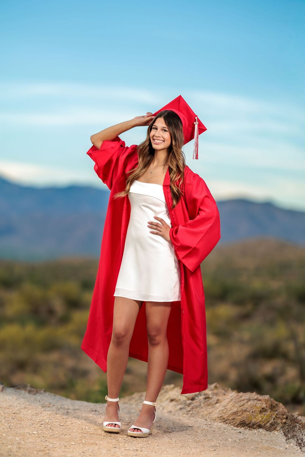 Tucson, AZ senior girl in the desert at golden hour with a beautiful sunset on big rocks