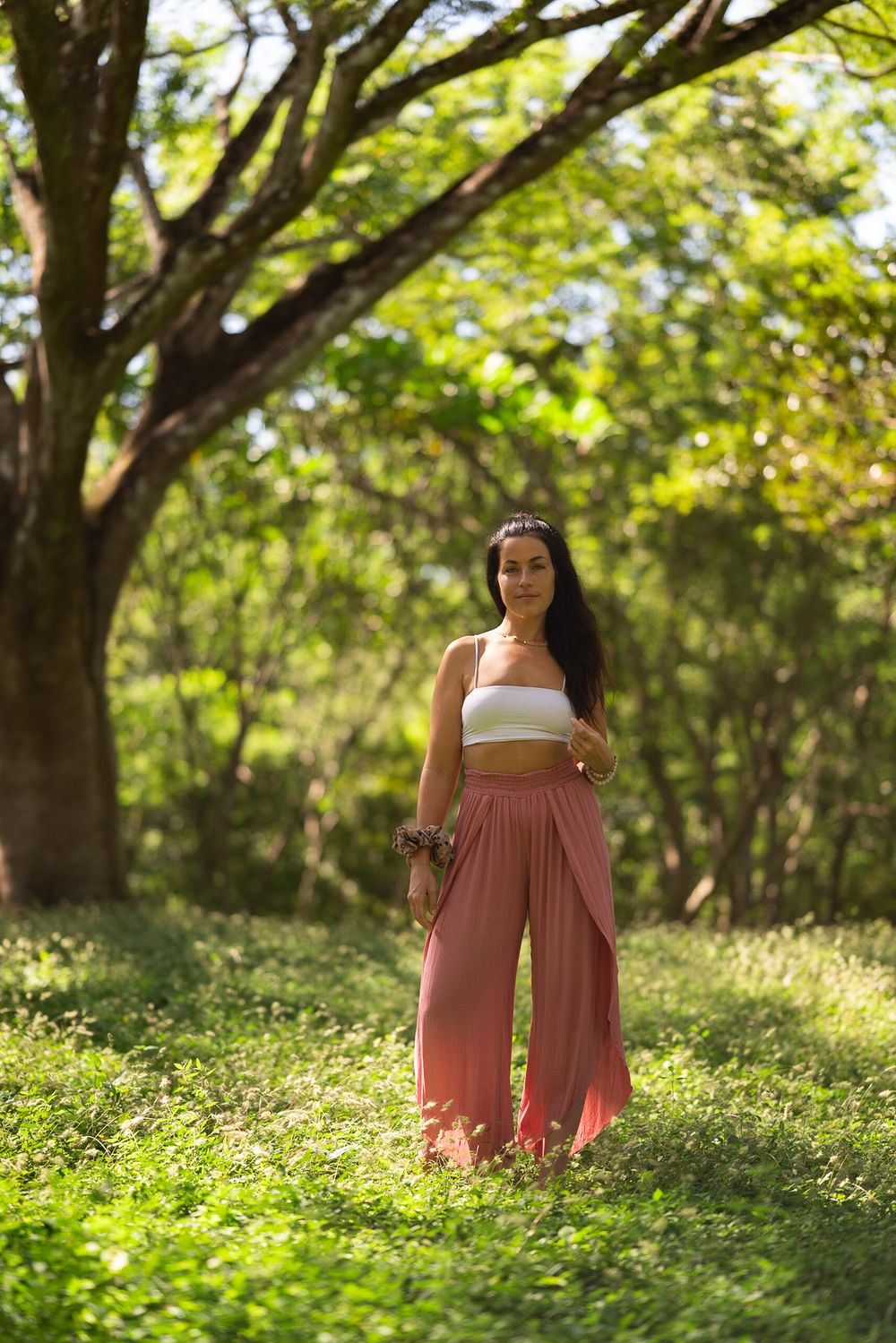 Garden pathway scene with soft natural lighting and flowing pink pants.
