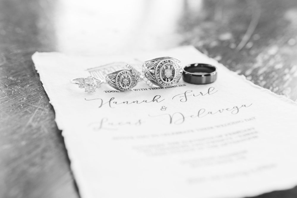 Wedding rings and handwritten text captured in artistic black and white photography.