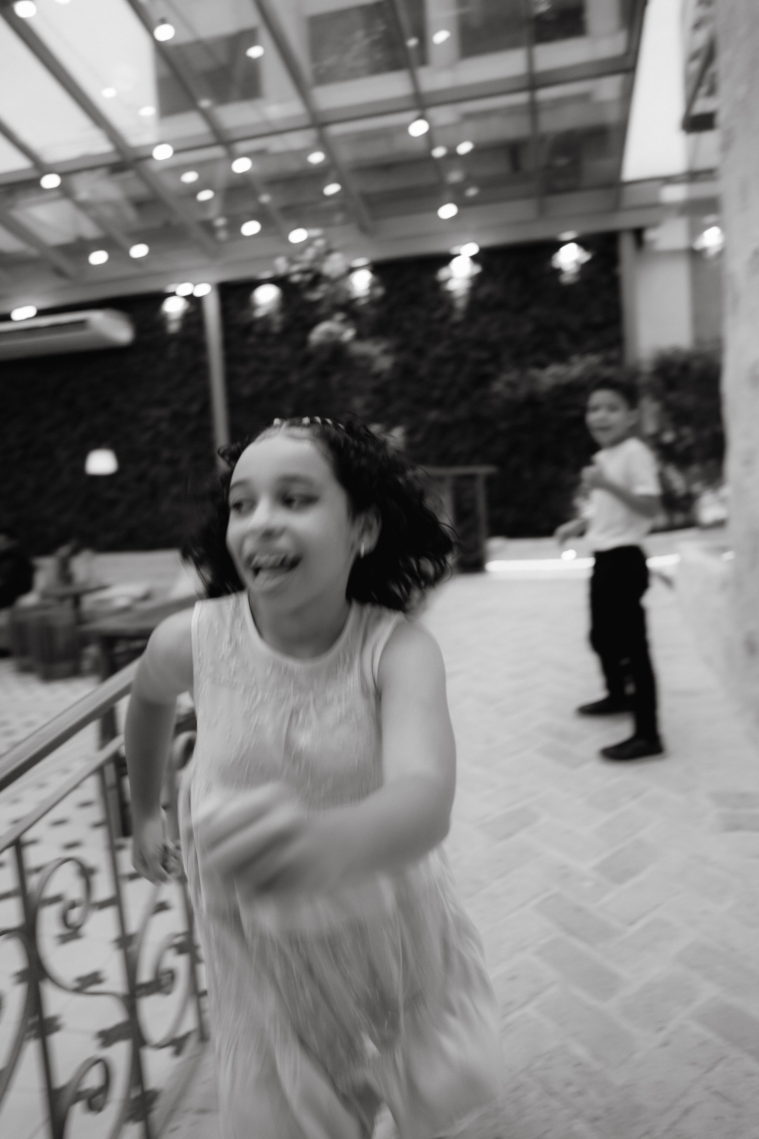 Wedding guest dancing and celebrating at an indoor reception venue.