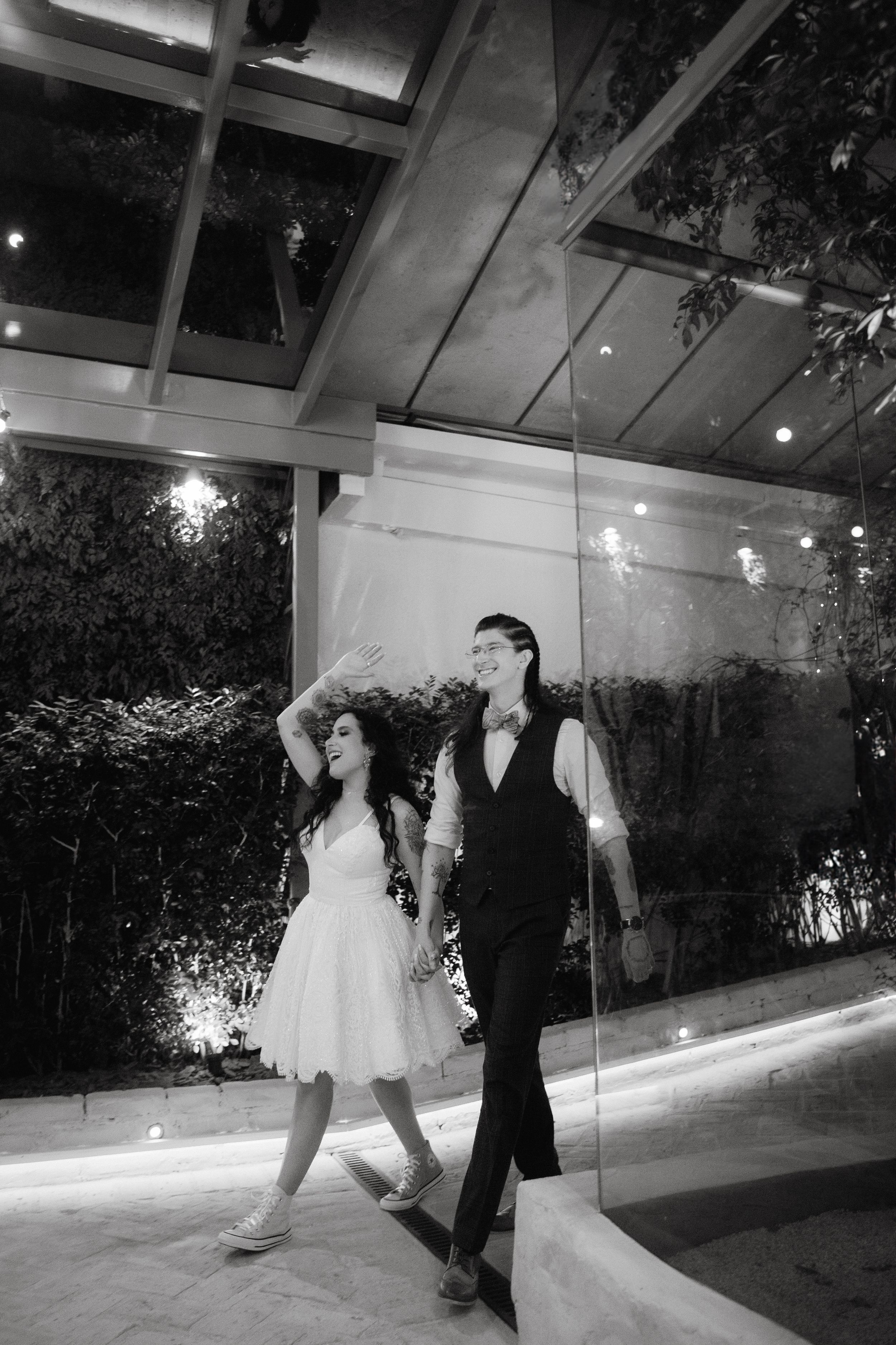 Couple dancing together at an elegant indoor wedding venue.