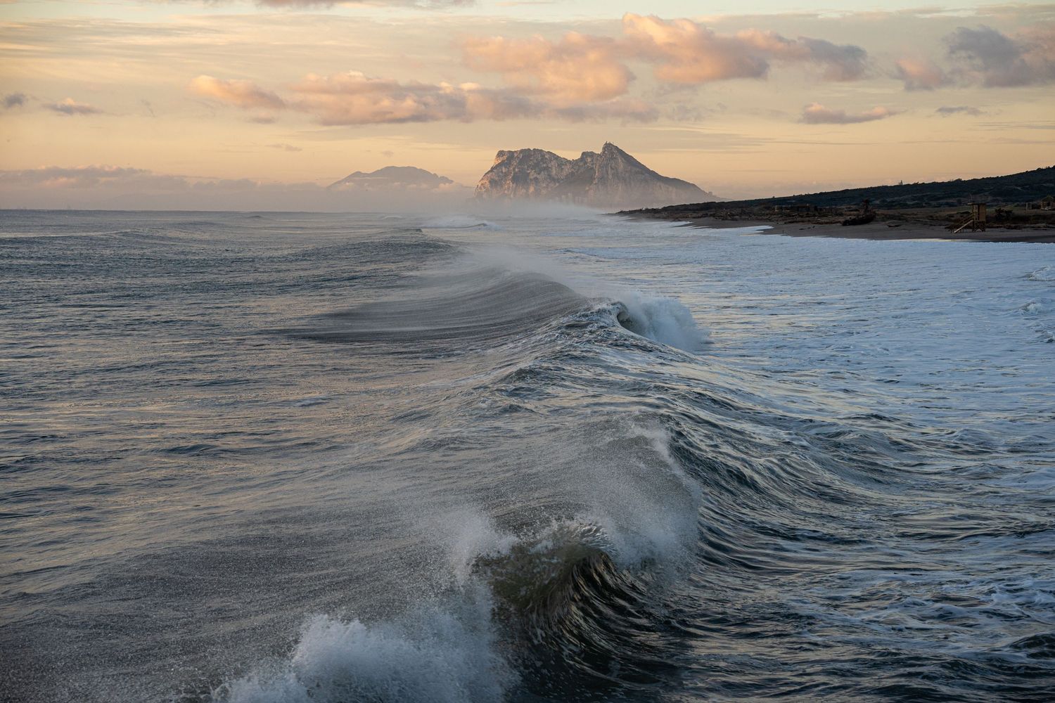 Waves crash onto bunker beach in front of Gibraltar