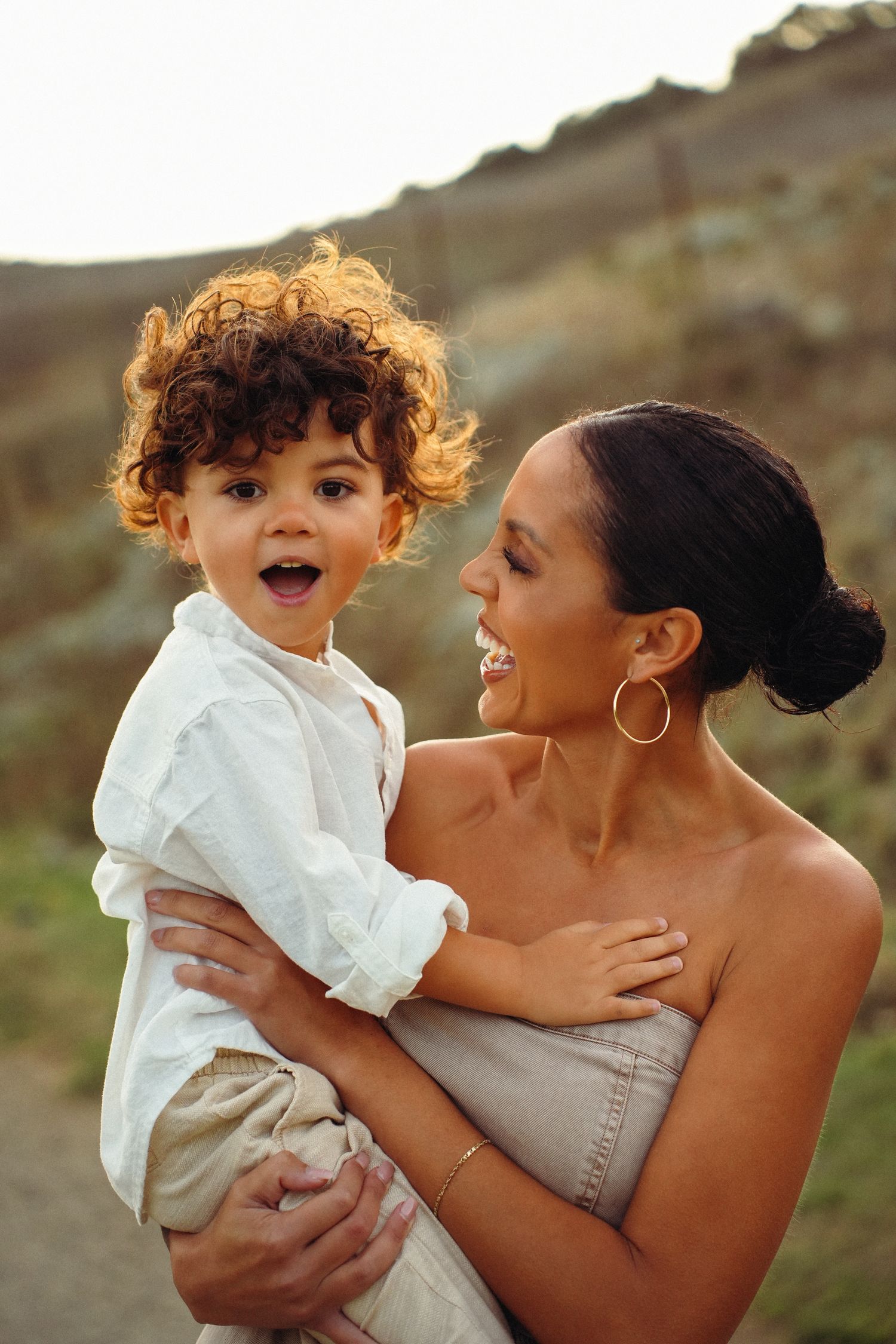 A heartwarming outdoor photo series showing tender moments between parent and child against a natural backdrop.