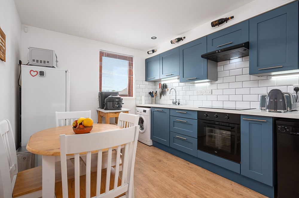 Modern kitchen with stainless steel appliances in a north lanarkshire apartment