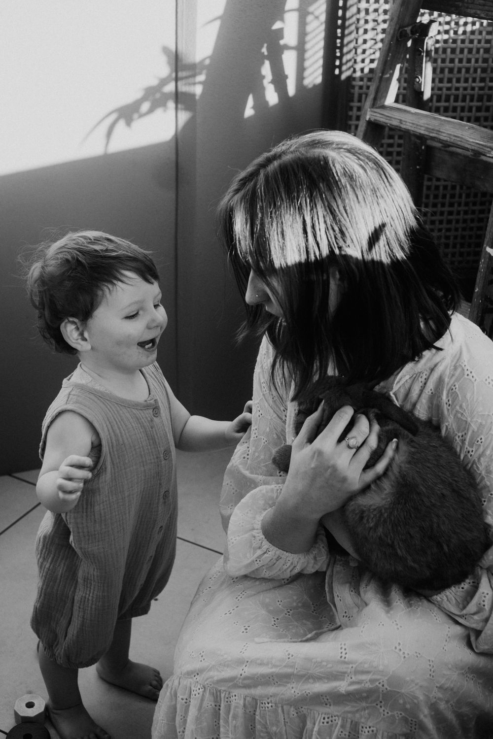 A sequence of black and white photos capturing tender family interactions.