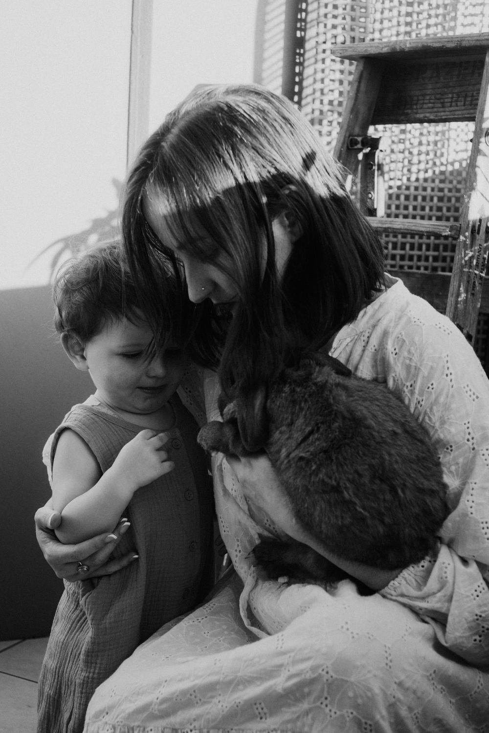 A series of intimate black and white family portraits captured indoors.