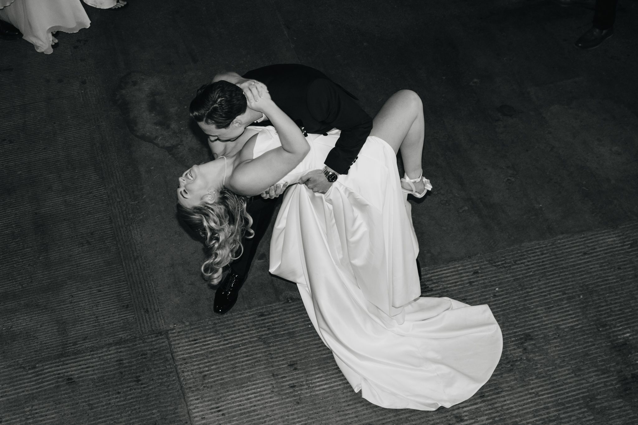 A dancer in a flowing white dress performs a dramatic spinning movement captured in a black and white photograph.
