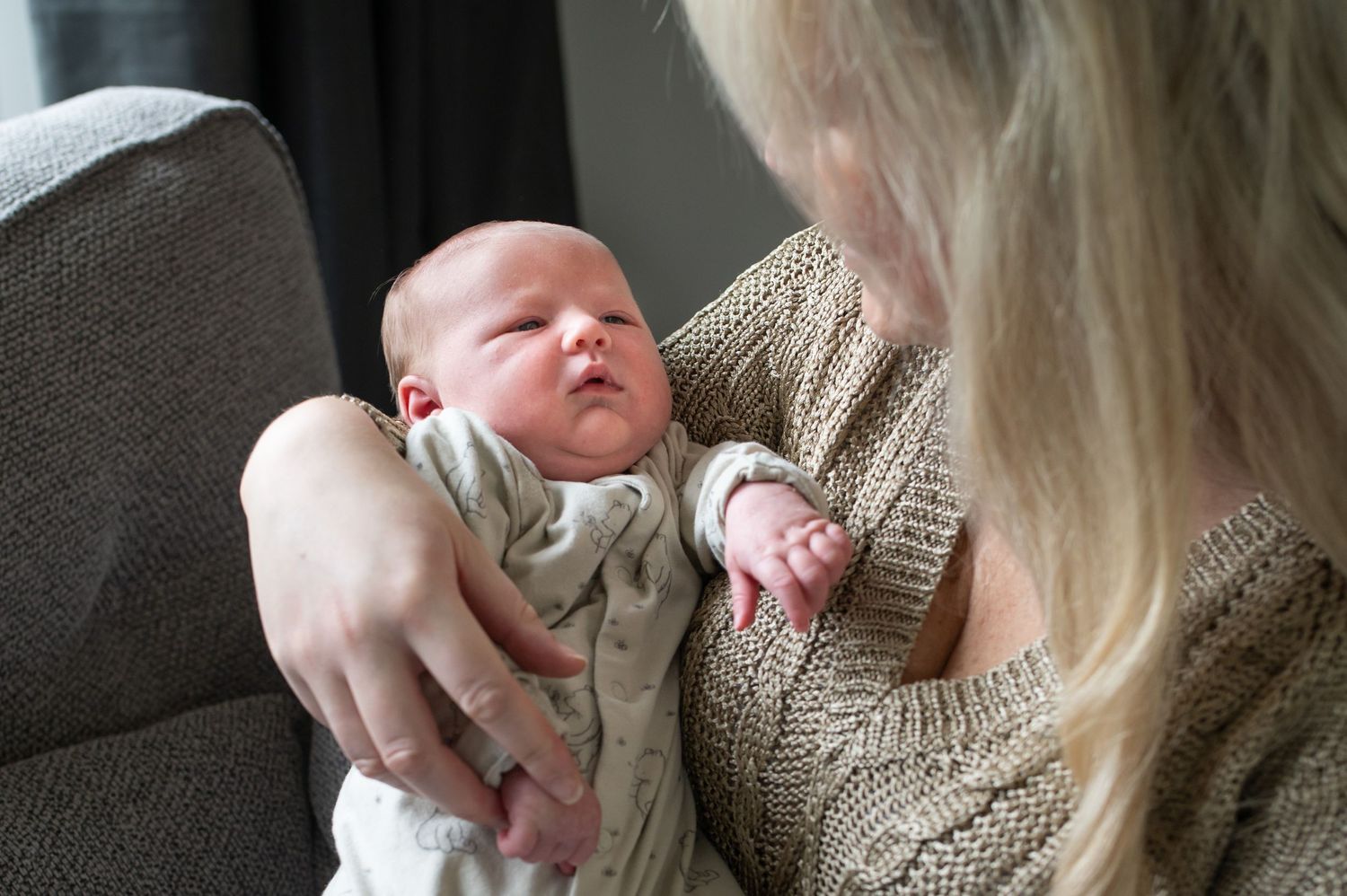 Newborn boy, at 3 weeks old, looking at his mum as she holds him close. Sarah Frame Photography, Newborn photographer