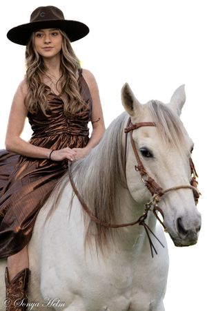 Elegant western photoshoot featuring white horse and bronze dress against white background.