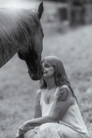 Moody black and white portrait showing intimate moment between horse and person outdoors. Sonya Helm Equine Photography, Bristol, TN
