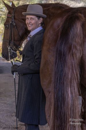 Equestrian in vintage-style attire standing beside a beautifully groomed brown horse. Sonya Helm Equine Photography, Bristol, TN